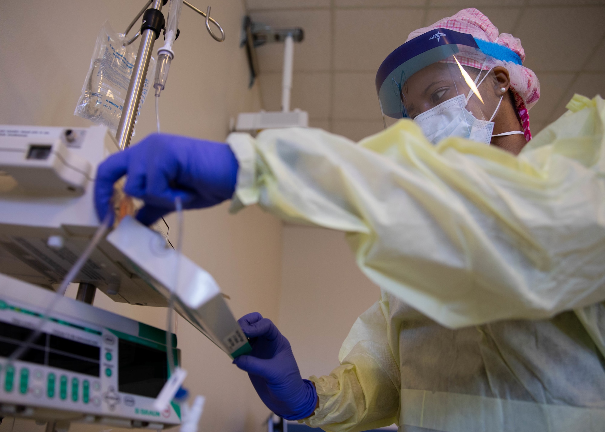 U.S. Air Force Capt. Arielle Watson, assigned to the 94th Aeromedical Staging Squadron, starts a monitor to care for a patient at Queens Hospital in Queens, N.Y., May 13, 2020.