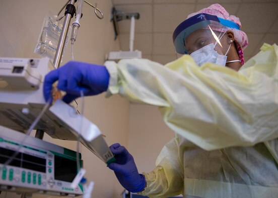 U.S. Air Force Capt. Arielle Watson, assigned to the 94th Aeromedical Staging Squadron, starts a monitor to care for a patient at Queens Hospital in Queens, N.Y., May 13, 2020.