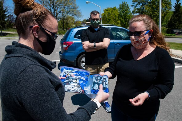 Senior Master Sgt. Jessica Davis, 32nd Aerial Port Squadron first sergeant, receives masks as part of a donation to the First Sergeant’s Association by Sharon Abner, wife of 911th Aeromedical Staging Squadron Nurse Capt. Geoffrey Abner, at the Pittsburgh International Airport Air Reserve Station, Pennsylvania, May 13, 2020. The Ebner family not only donated masks, but also donated approximately $850 worth of food to the First Sergeant’s Association food drive that’s being held to help local service members and veterans in need due to the COVID-19 pandemic.