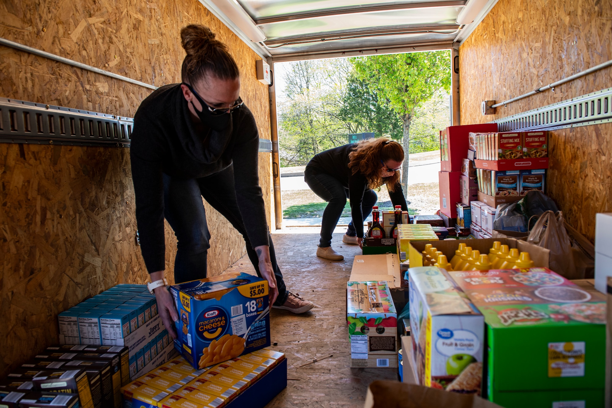 Senior Master Sgt. Jessica Davis, 32nd Aerial Port Squadron first sergeant, and Sharon Abner, wife of 911th Aeromedical Staging Squadron Nurse Capt. Geoffrey Abner, organize food donated to the First Sergeant’s Association food drive at the Pittsburgh International Airport Air Reserve Station, Pennsylvania, May 13, 2020. The First Sergeant’s Association food drive was held to help local service members and veterans in need due to the COVID-19 pandemic.