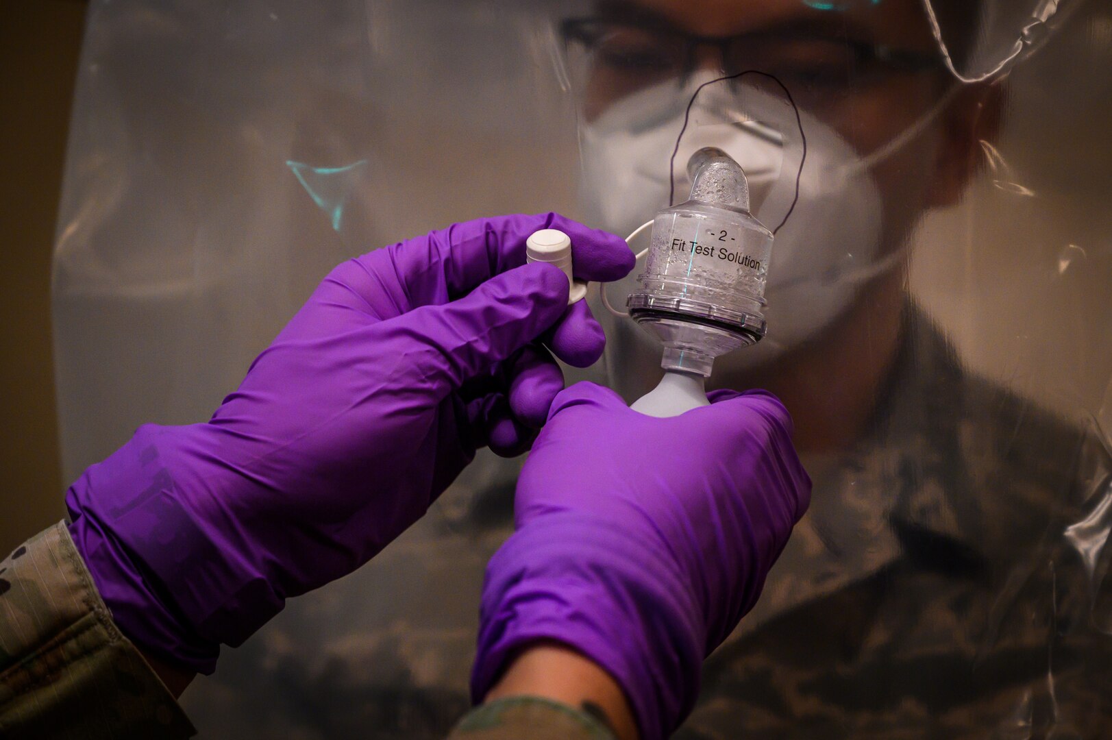 A New Jersey National Guard Soldier, 21st Weapons of Mass Destruction-Civil Support Team (WMD-CST), conducts a mask fitting test for an Airman at a long-term care facility, Andover N.J., May 8, 2020. The WMD-CST has been training Soldiers and Airmen on proper ways to wear personal protective equipment during the COVID-19 relief effort.