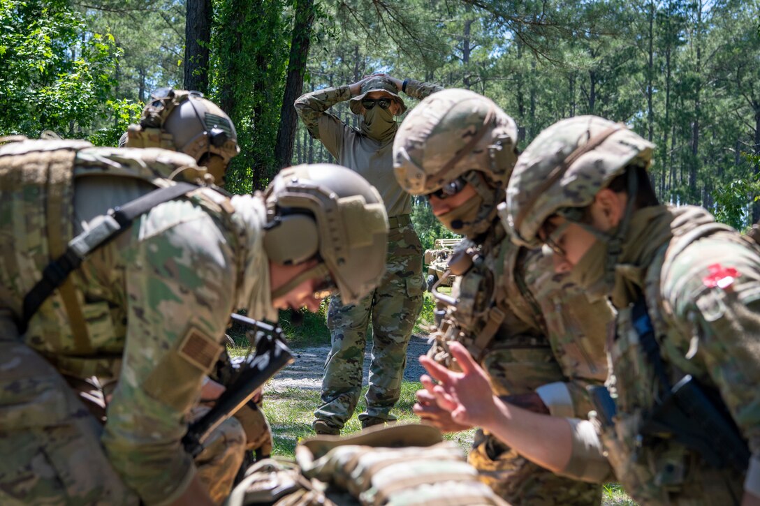 Airmen treat a patient during a training scenario