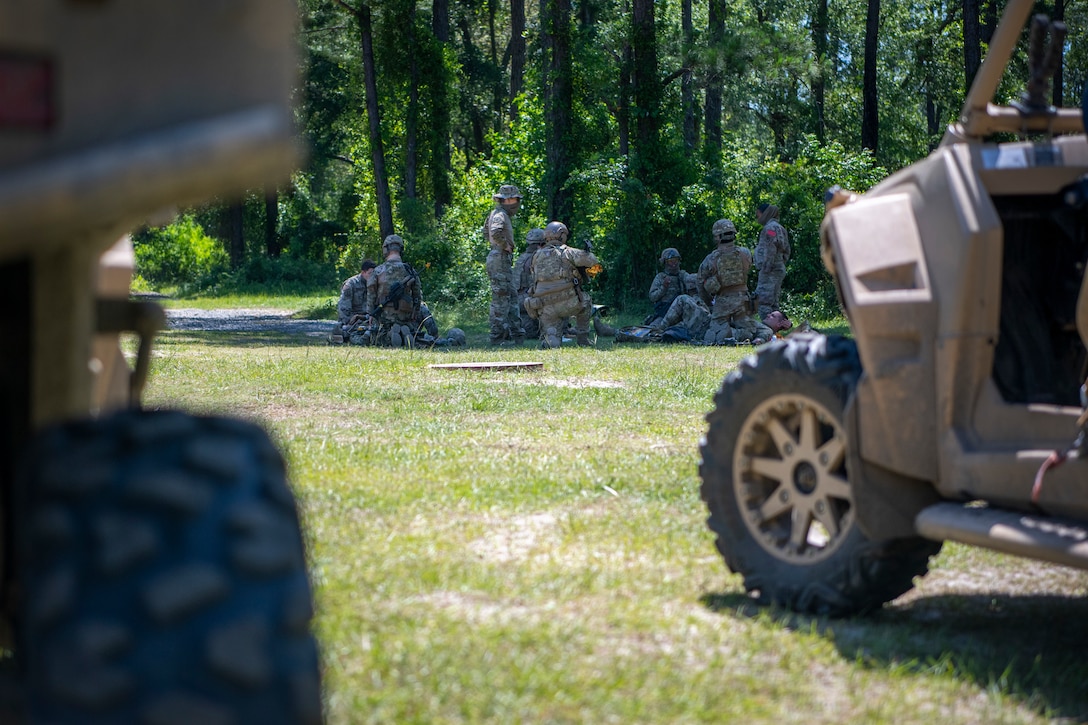 Airmen treat a patient during a training scenario
