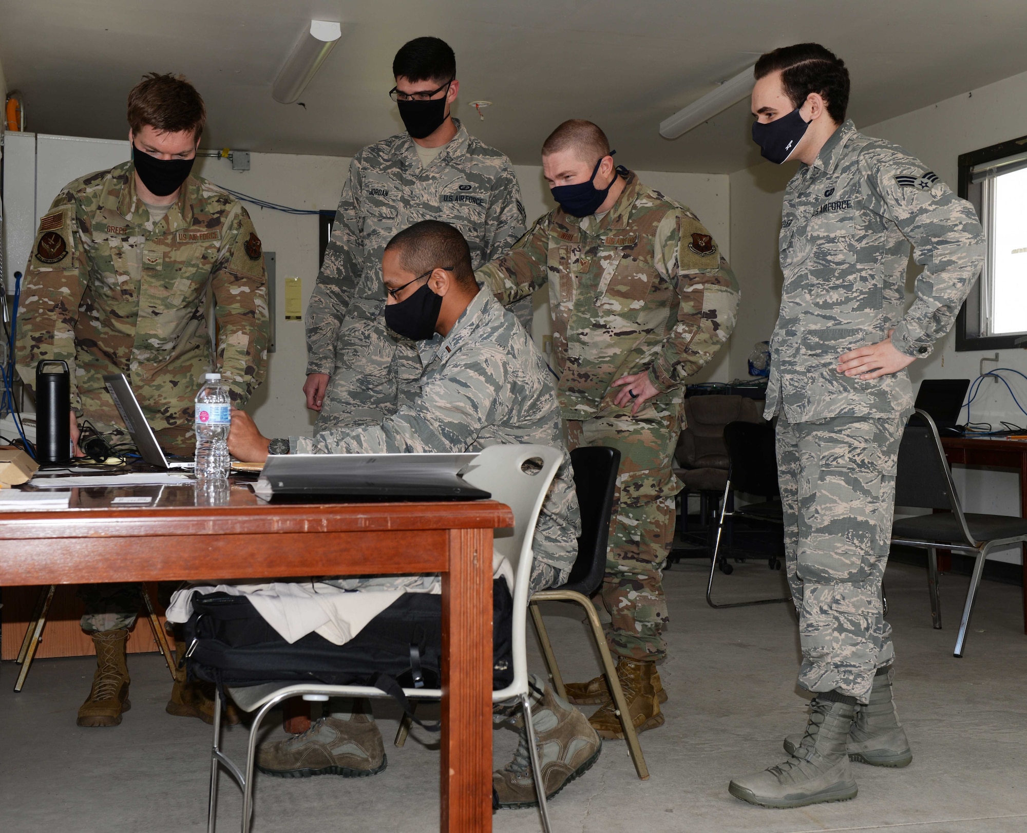 Contracting Airmen work on contracts