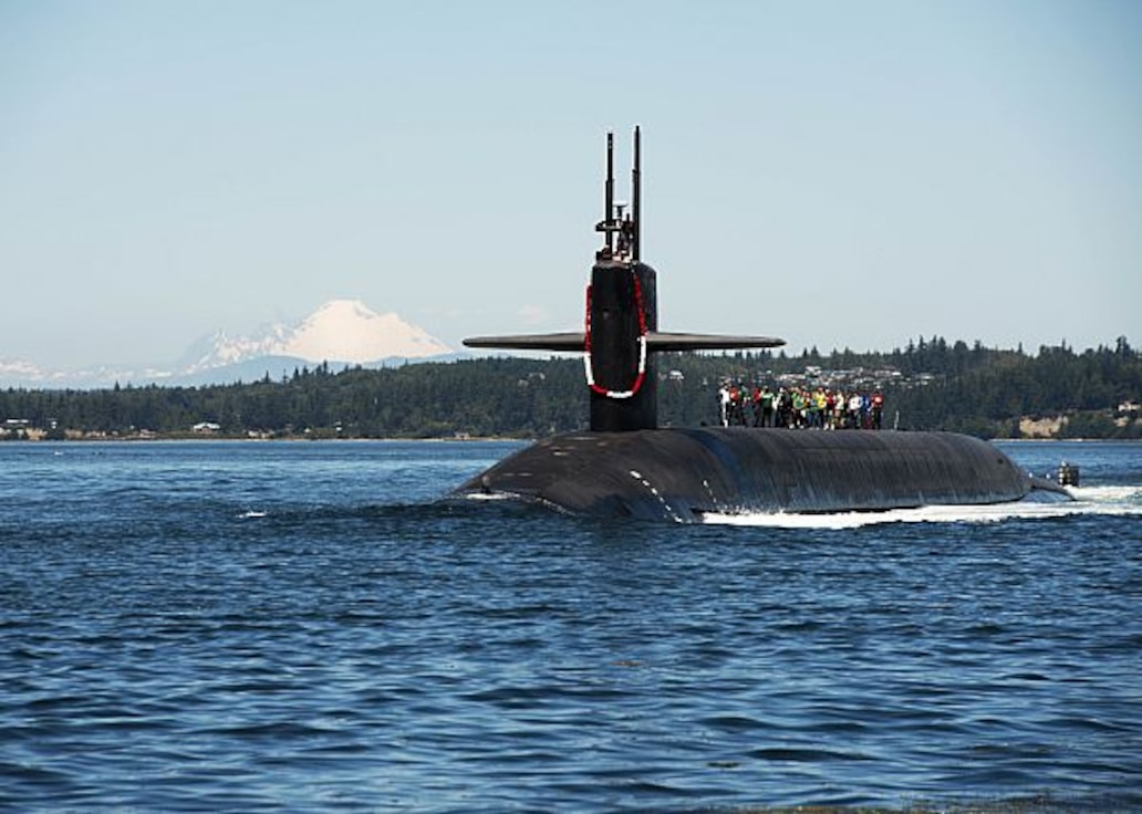 180712-N-UD469-0021
PUGET SOUND, Wash. (July 12, 2018) Members of the Big Red Sub Club ride the Ohio-class ballistic missile submarine USS Nebraska (SSBN 739) through the Hood Canal as the boat returns home to Naval Base Kitsap-Bangor following its first strategic patrol since 2013. Nebraska recently completed a 41-month engineered refueling overhaul, which will extend the life of the submarine for another 20 years. (U.S. Navy photo by Mass Communication Specialist 1st Class Amanda R. Gray/Released)
