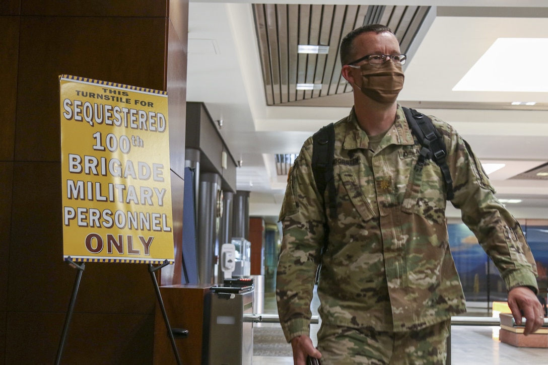 Maj. Jeremiah VanDorsten, a 100th Missile Defense Brigade (GMD) deputy director, enters the secure facility where the 100th Brigade operates as the only missile defense brigade in the U.S. military April 30. Since the onset of the pandemic, the 100th has implemented measures to ensure the continued execution of its mission including sequestering crew members from their homes and families.