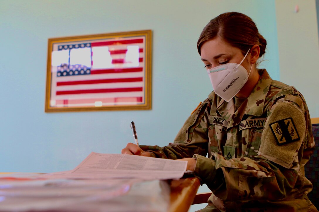 A guardsman preparing paperwork.