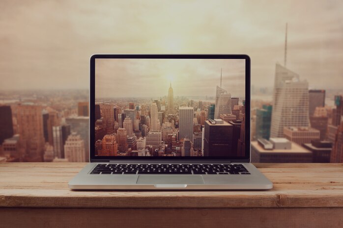 Laptop computer over New York city skyline. Retro filter effect.