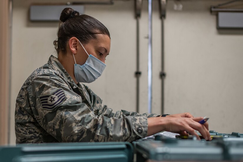 An airman prepares food for quarantined airmen.