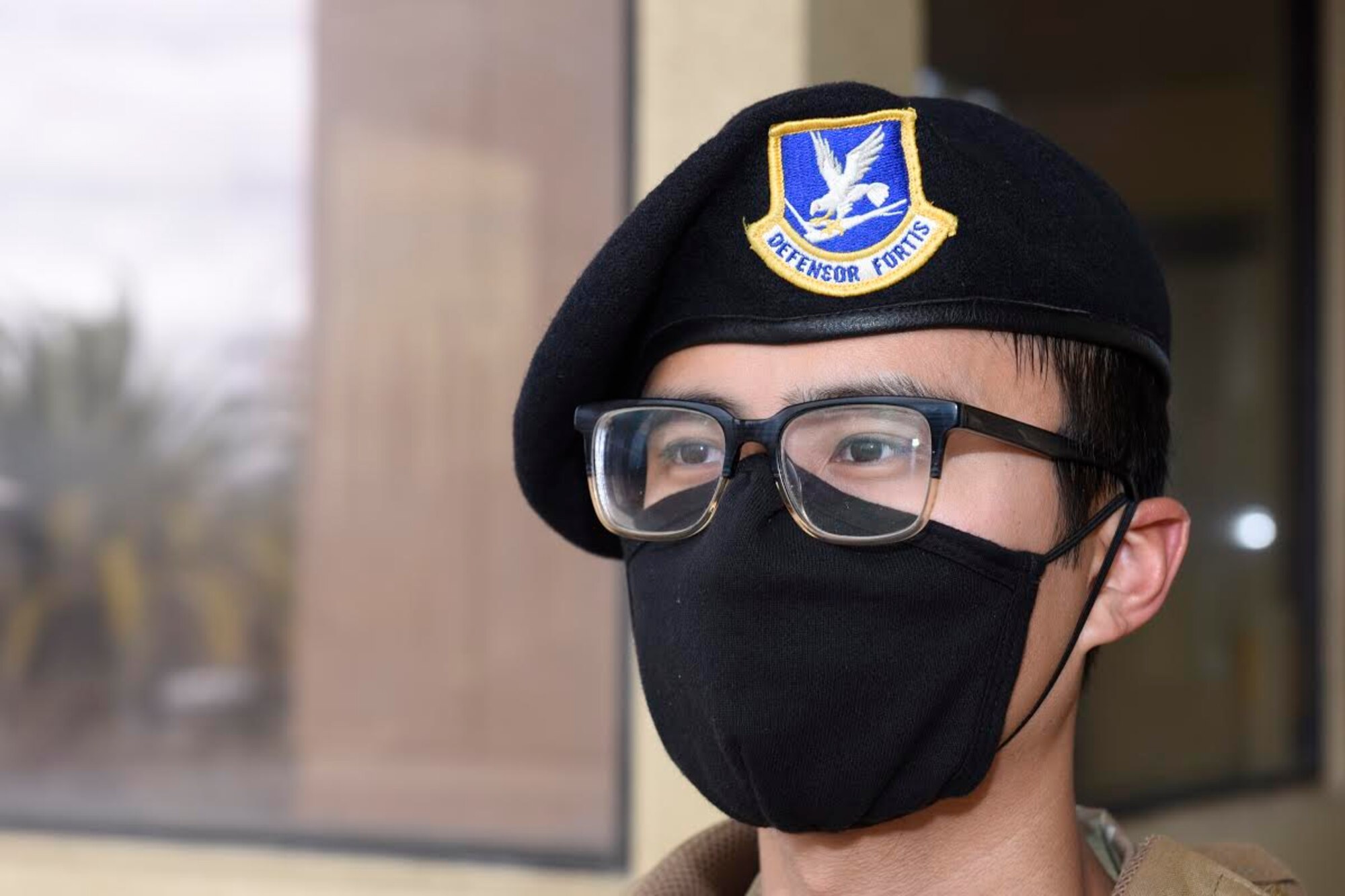 U.S. Air Force Airman 1st Class Jason Nguyen, 60th Security Forces Squadron entry controller, keeps watch at the main gate May 11, 2020, at Travis Air Force Base, California. Security forces Airmen performing entry control duties at Travis AFB gates are required to wear masks, gloves and eye protection to prevent exposure to the coronavirus. (U.S. Air Force photo by Airman 1st Class Cameron Otte)