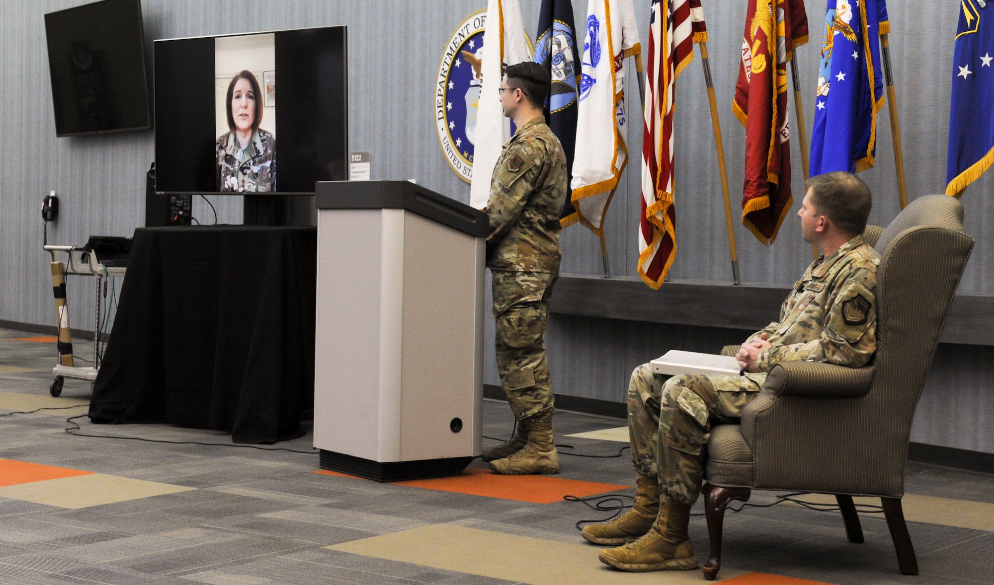Lt. Gen. Mary O’Brien, Deputy Chief of Staff for Intelligence, Surveillance, Reconnaissance and Cyber Effects Operations, makes remarks on-screen during a May 8, 2020, farewell ceremony for Col. Parker Wright (seated), commander, National Air and Space Intelligence Center. Steering away from the typical change of command activities because of the ongoing COVID-19 response, the ceremony was instead streamed live to the workforce through the Department of Defense’s Commercial Virtual Remote Environment. Wright, who has been confirmed for appointment to the rank of brigadier general, will be leaving NASIC to go to the Air Staff where he will serve as Director of ISR Operations. (U.S. Air Force photo by Senior Airman Samuel Earick)