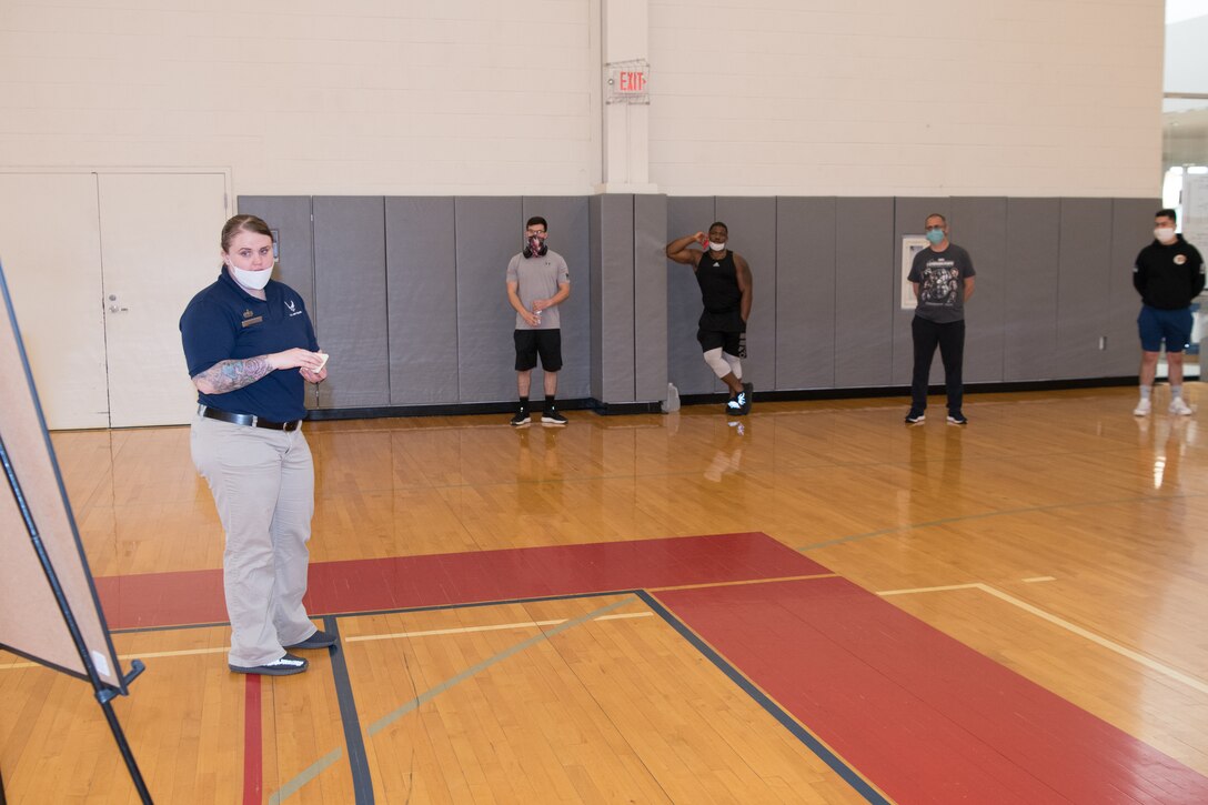 Tech Sgt. Leticia Anderson, 436th Force Support
Squadron resource manager, briefs a group of
Team Dover Airmen at the fitness center, May 20,
2020, at Dover Air Force Base, Delaware. Upon
their first return to the fitness center, all patrons
must attend a mandatory brief to review new
safety guidelines. (U.S. Air Force photo by
Mauricio Campino)