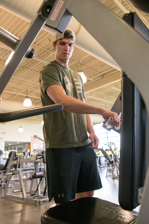 Staff Sgt. Leighton Montgomery, 436th Security
Forces Squadron base defense operation center
controller, wipes down gym equipment after
completing his workout at the fitness center, May
20, 2020, at Dover Air Force Base, Delaware. The
fitness center’s Phase I reopening guidelines
require patrons to wipe off workout machines
before and after use. (U.S. Air Force photo by
Mauricio Campino)