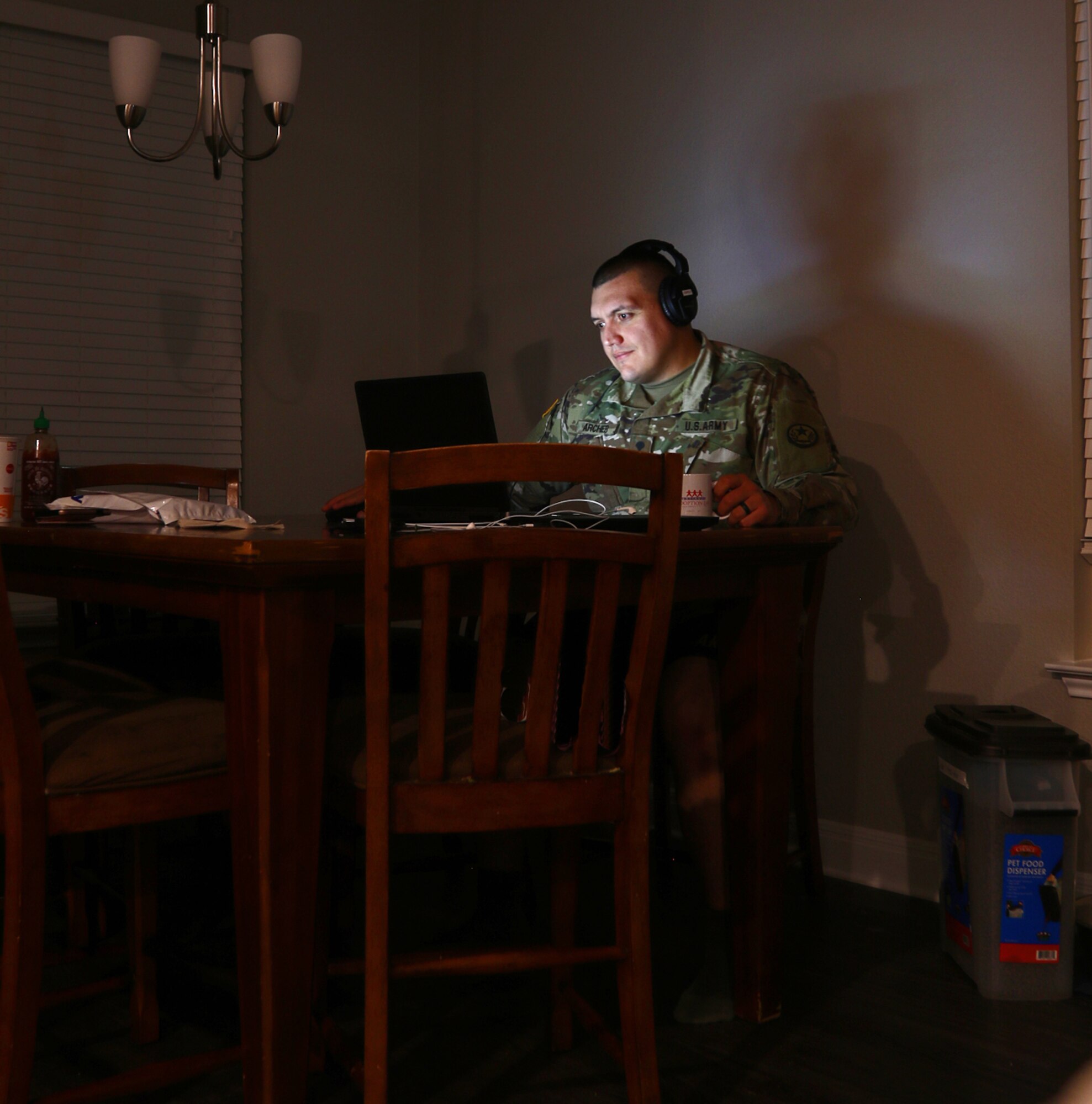 Texas Army National Guard Spc. Jason Archer, attached to the 100th Mobile Public Affairs Detachment, 71st Troop Command, logs on to a videoconference at his home in Leander, Texas, April 6, 2020. Archer’s unit continued training remotely during the state ordered shelter-in-place.
