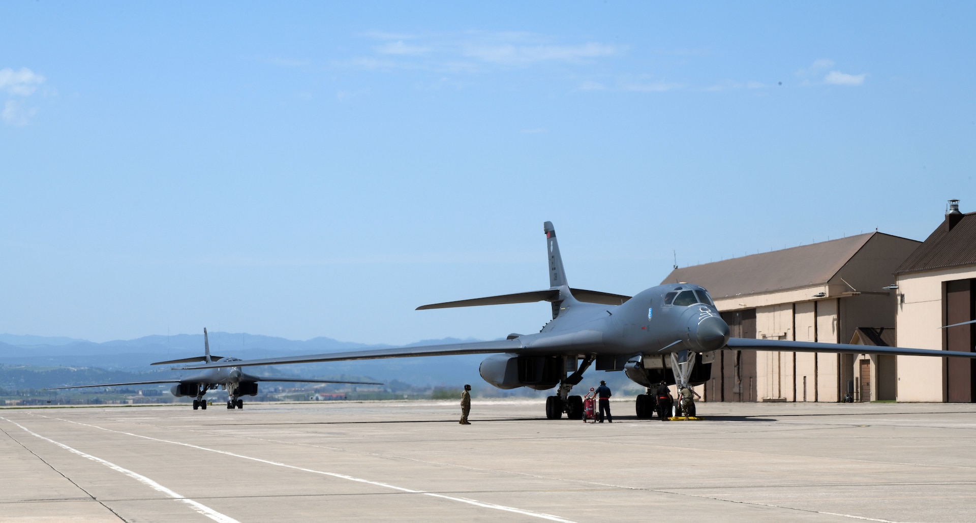 Two B-1B Lancers assigned to the 34th Bomb Squadron taxi in to the apron on the flight line at Ellsworth Air Force Base, S.D., May 20, 2020.  The two bombers completed a long-range, long-duration Bomber Task Force mission within the U.S. European Command area of responsibility. BTF missions are representative of the U.S. commitment to integrate with NATO and allied partners to ensure regional security. (U.S. Air Force photo by Airman 1st Class Christina Bennett)