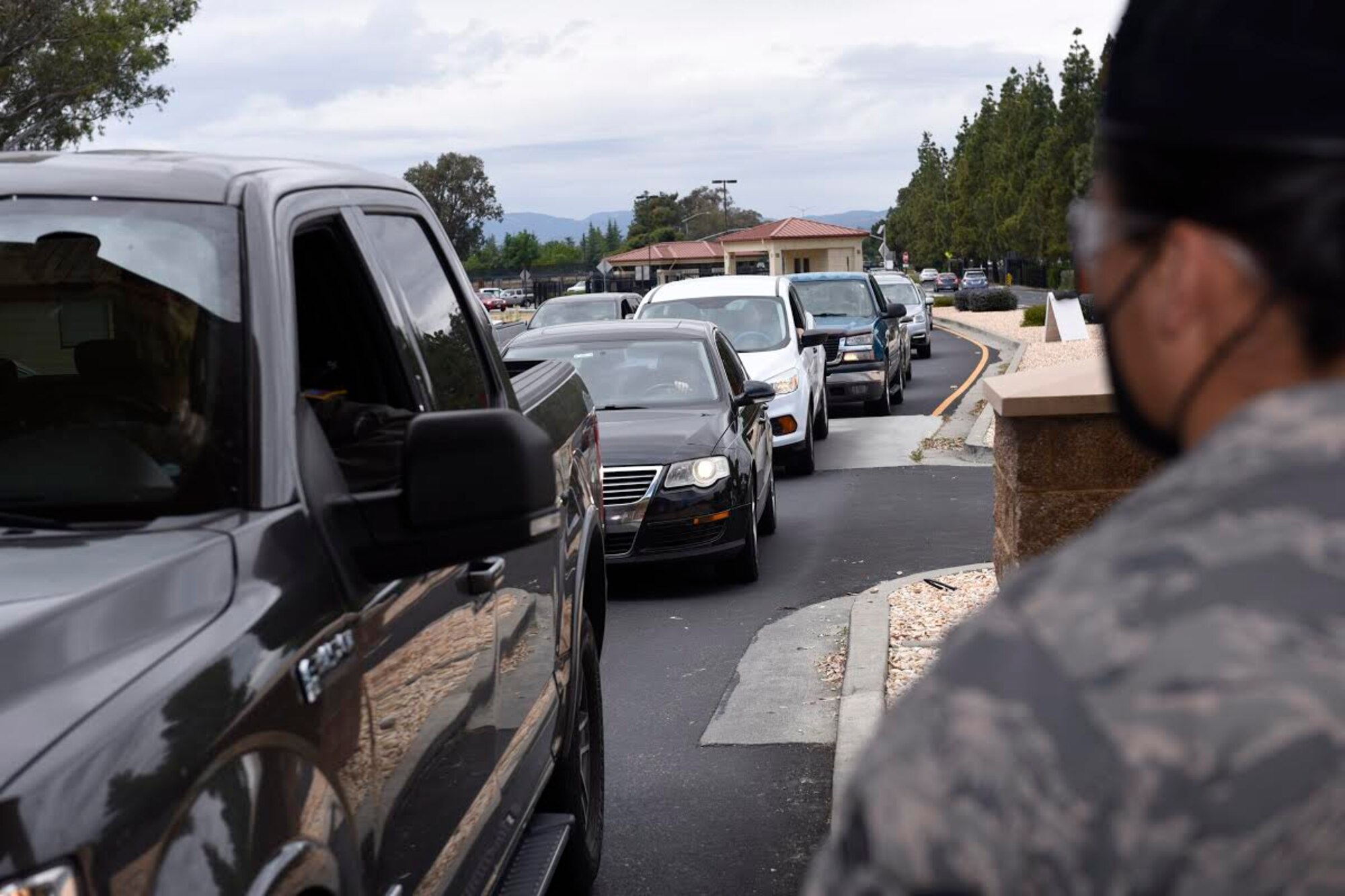 U.S. Air Force Airman 1st Class Hannah Hoskins, 60th Security Forces Squadron entry controller, watches vehicles as they approach the main gate May 11, 2020, at Travis Air Force Base, California. Security forces Airmen at Travis AFB protect thousands of people and essential resources for three wings. (U.S. Air Force photo by Airman 1st Class Cameron Otte)