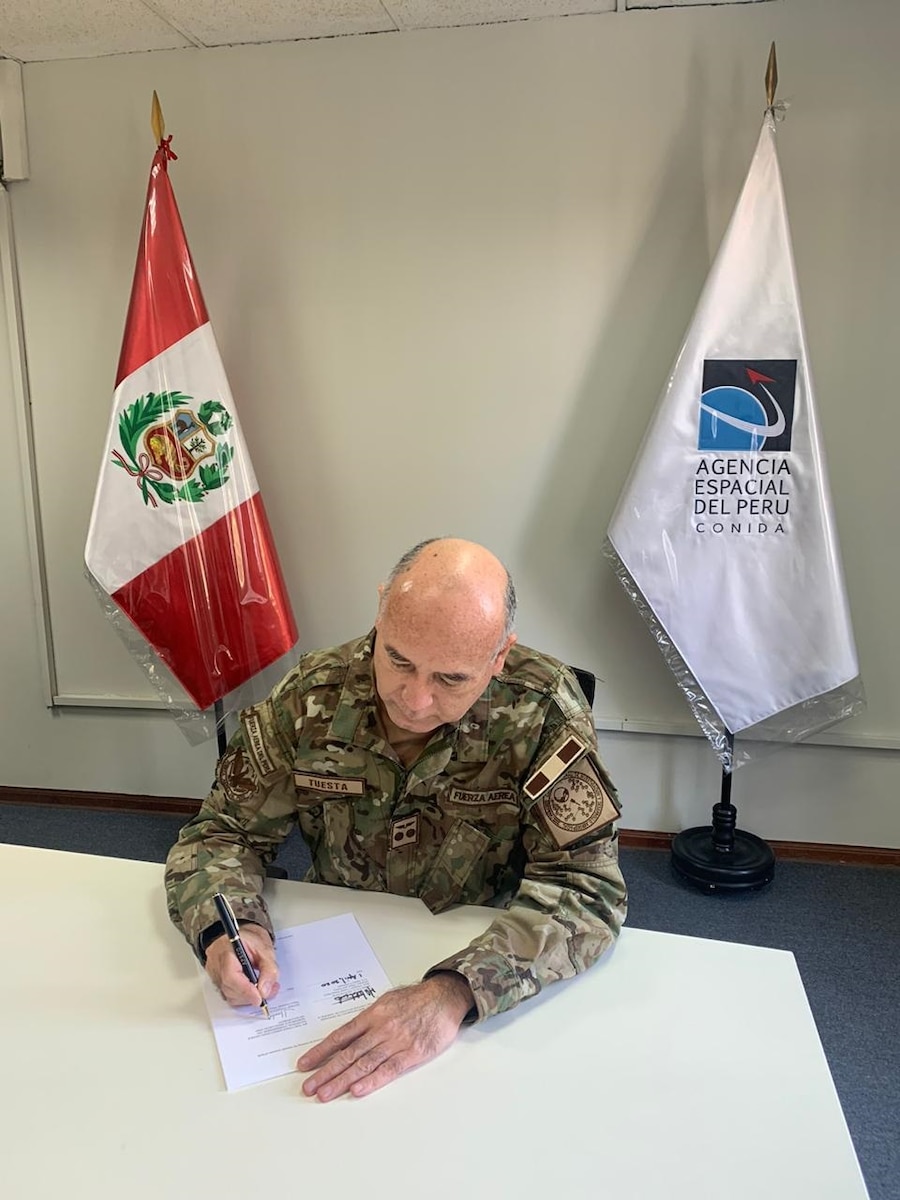 Maj. Gen. Javier Tuesta Marquez, National Commission on Aerospace Research and Development (CONIDA), Republic of Peru, signs a space data sharing Memorandum of Understanding between his country and the United States recently.
