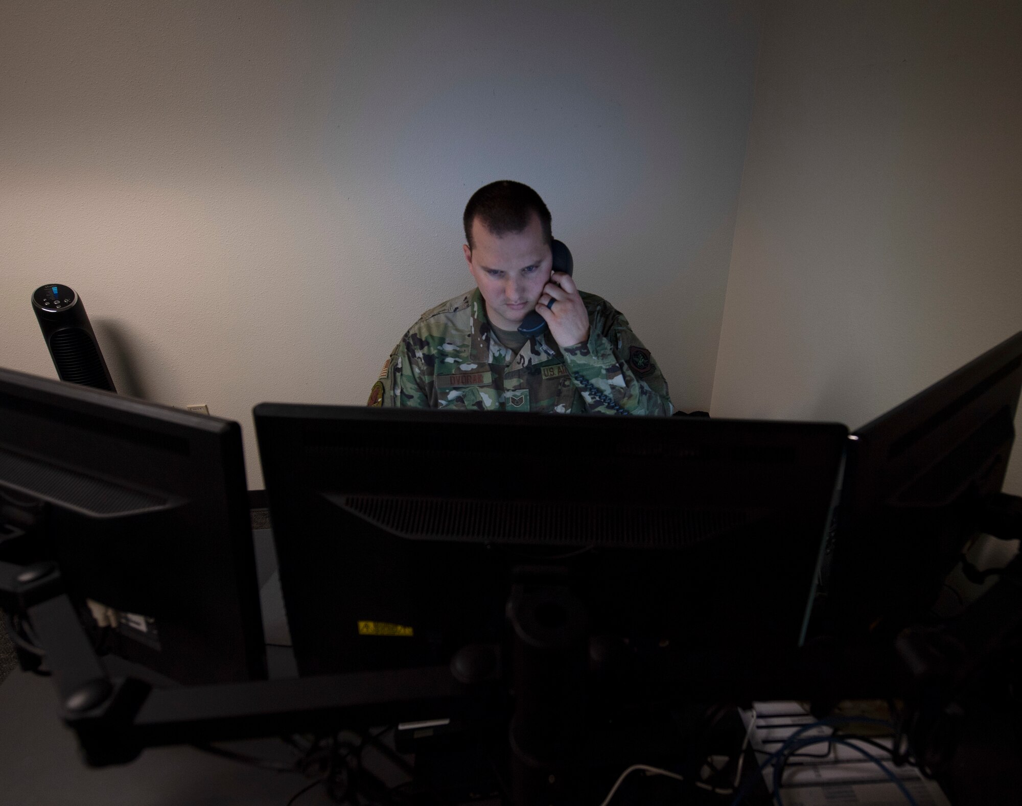 Airmen assigned to the 60th Communications Squadron work behind computers to keep Travis' mission operating.