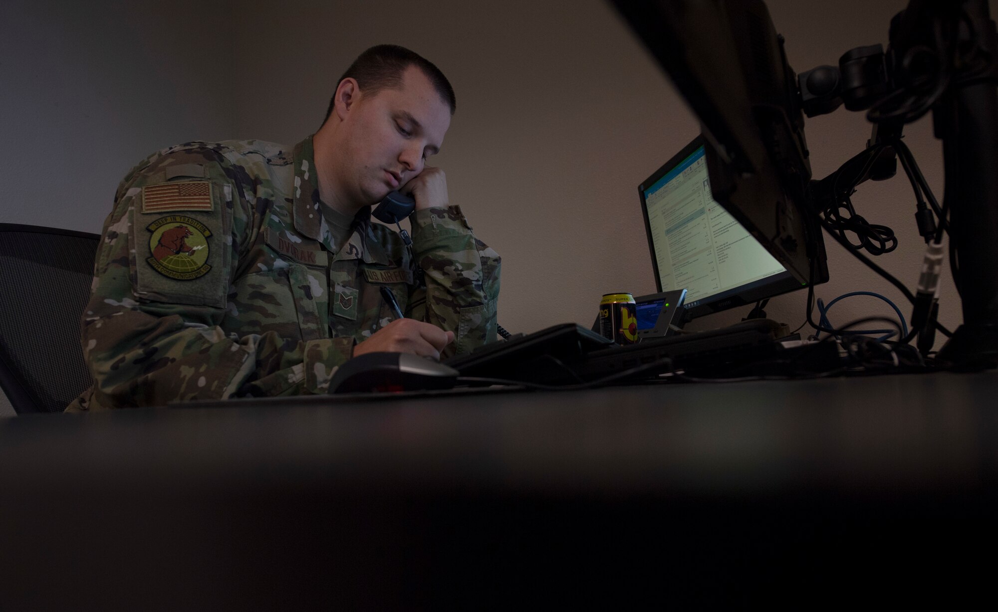 Airmen assigned to the 60th Communications Squadron work behind computers to keep Travis' mission operating.