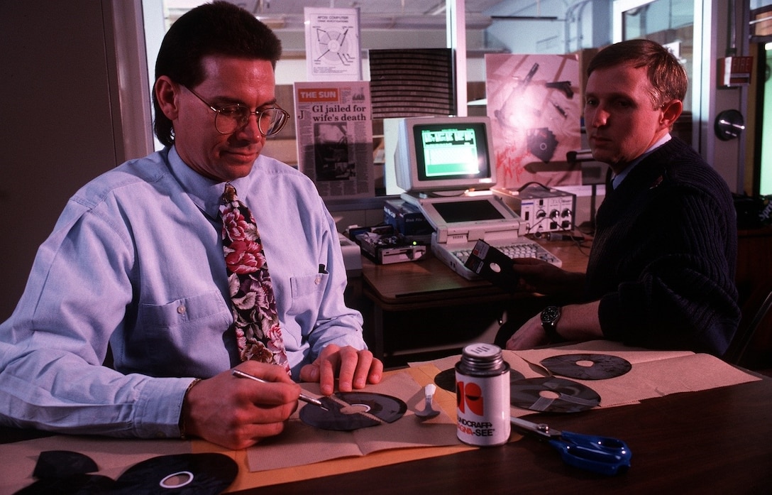 OSI Special Agents Jim Christy (left) and Ed Cutchins developed the disk-splicing technique in less than two days after industry experts declared it a near impossibility. (Photo courtesy U.S. National Archives)