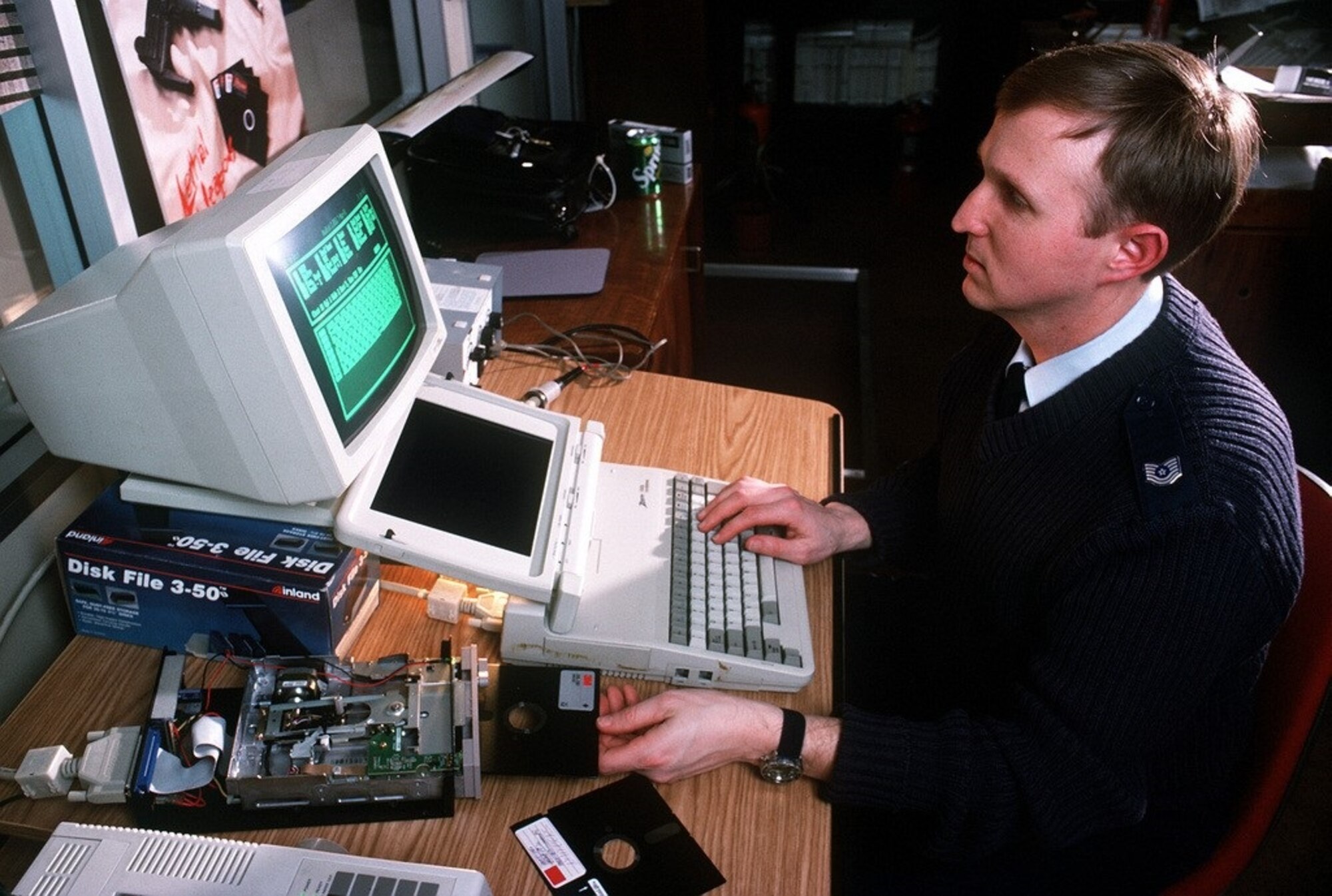 OSI Special Agent Ed Cutchins inserted a repaired floppy disk into the drive to review its data. (Photo courtesy U.S. National Archives)