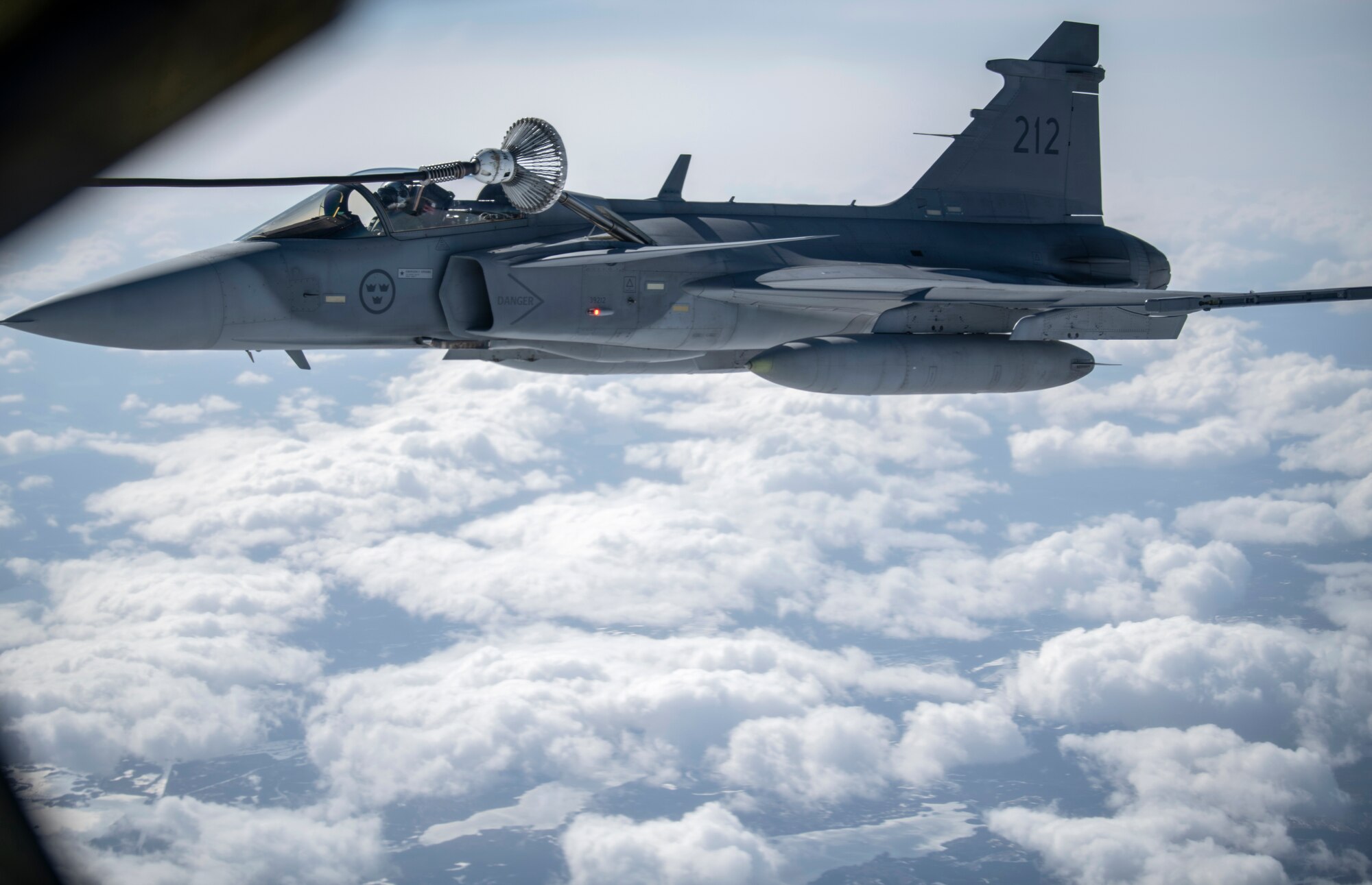 A Swedish Armed Forces Gripen receives fuel from a KC-135 Stratotanker from the 100th Air Refueling Wing, RAF Mildenhall, England, during a Bomber Task Force Europe mission over Sweden, May 20, 2020. The mission marked the first time B-1s have flown over Sweden to integrate with Swedish Gripens while conducting close-air support training with Swedish Joint Terminal Attack Controller ground teams at Vidsel Range. (U.S. Air Force photo by Tech. Sgt. Emerson Nuñez)