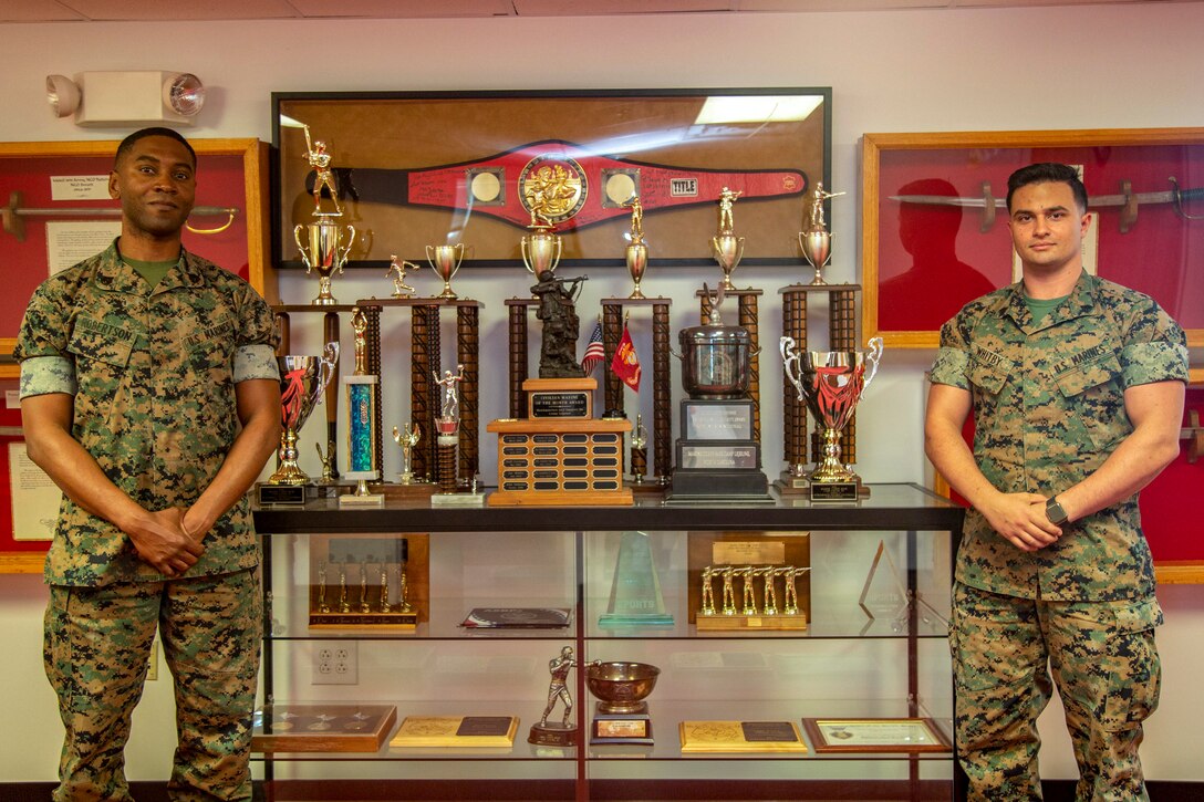 U.S. Marine Corps Staff Sgt. Hubert Robertson, left, S-3 assistant training chief and Sgt. Christopher Whitby, right, watch chief with Provost Marshal Office, both with Headquarters and Support Battalion, Marine Corps Installations East-Marine Corps Base Camp Lejeune, pose for a photo at building 8 on Marine Corps Base Camp Lejeune, North Carolina, May 13, 2020. Robertson and Whitby collaborated together and presented a new digital classroom for Marines attending Lance Corporals Leadership and Ethics Seminar. (U. S. Marine Corps photo by Cpl. Karina Lopezmata