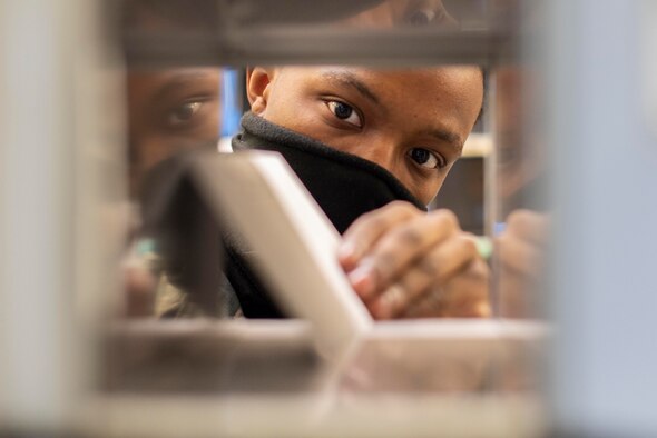 Postal clerk Airmen inventory packages at the post office at RAF Mildenhall, England, May 19, 2020. Newly arrived packages are in-processed to ensure accountability of mail and alert customers to when their order has arrived. (U.S. Air Force photo by Airman 1st Class Joseph Barron)