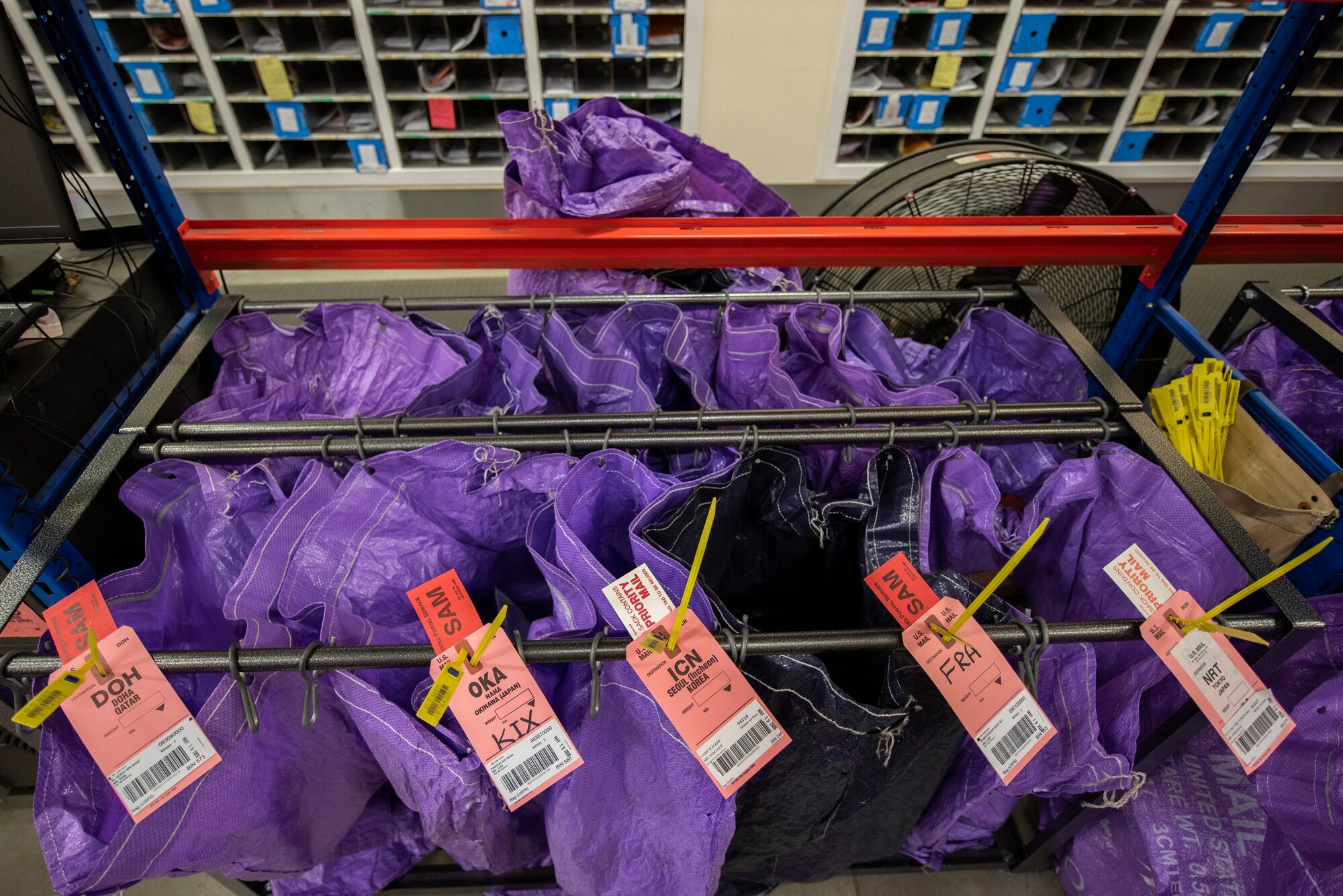 A collection of mail bags sit in the post office at RAF Mildenhall, England, May 19, 2020. The post office has operated continuously during COVID-19 to route both personal and official military mail to stateside and international destinations. (U.S. Air Force photo by Airman 1st Class Joseph Barron) (Portions of this photo have been blurred for security purposes)