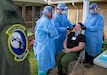 Col. Scott Coradi (left), 111th Medical Group commander and medical adviser for Pennsylvania Task Force South trains members of Task Force Ghostrider, Spc. Joshua Vargo (center) and Spc. Kristien Quintanilla (right) on proper procedures how to administer a COVID-19 test in Lancaster, Pa., on May 19, 2020.