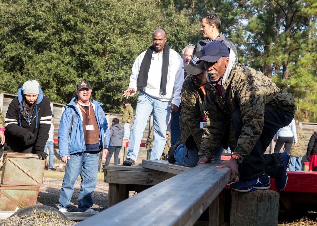 Attendees of the Educators Workshop participate in the Leadership Reaction Course aboard Marine Corps Recruit Depot Parris Island, South Carolina, Jan. 31, 2019. These educators traveled from Recruiting Station Fort Lauderdale to experience the Educators Workshop. The workshop allows educators to have an inside look at educational benefits and career opportunities in the Marine Corps. (U.S. Marine Corps photo by Lance Cpl. Jack A. E. Rigsby)