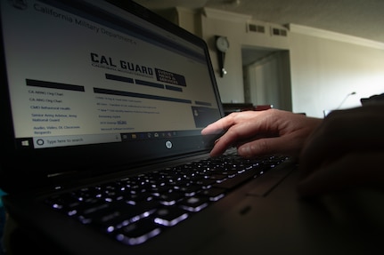 A California National Guard full-time technician works from home May 20, 2020, at Huntington Beach, California. Many Cal Guard full-time staff members are teleworking during the COVID-19 pandemic as a way of protecting themselves, their coworkers and high-risk family members from the virus.