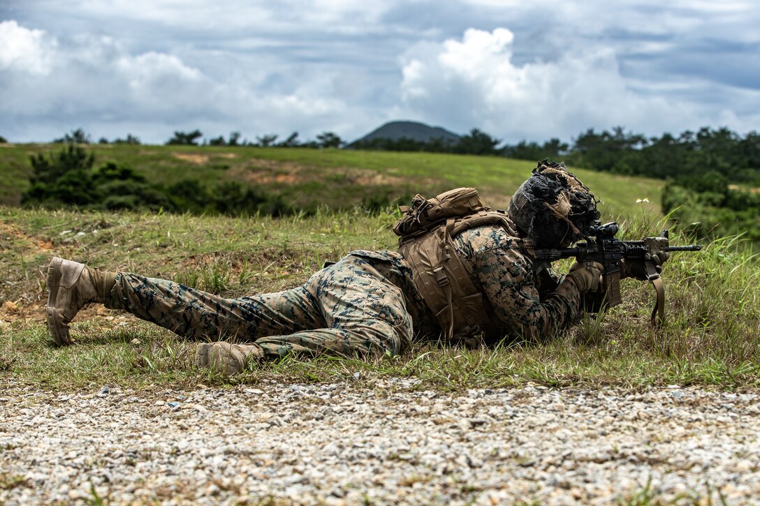 A U.S. Marine holds a defensive position during live- fire anti-armor transition drills on Camp Schwab, Okinawa, Japan, May 17, 2020.