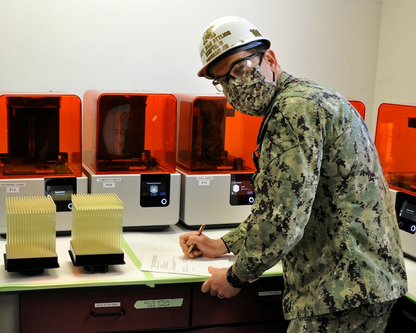 Navy officer signs a memorandum.