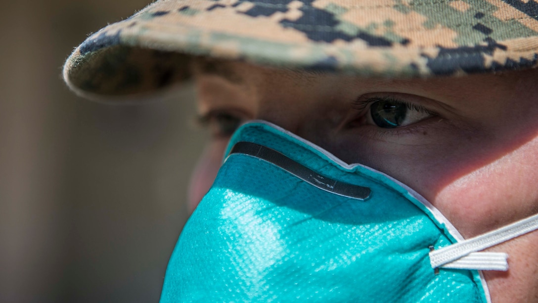 A U.S. Marine practices precautionary measures by wears proper protective equipment on Marine Corps Air Station Miramar, Cali., March 25, 2020.