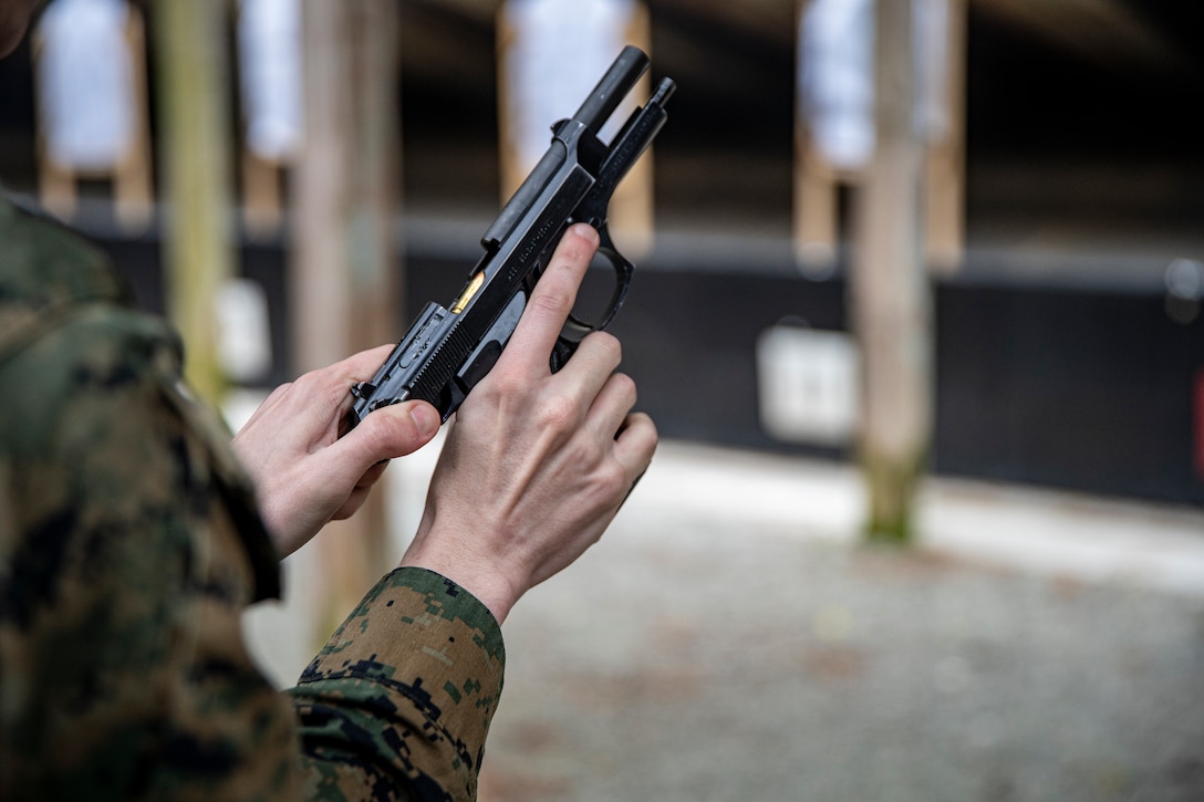 Sgt. Caleb Goodwin, an intelligence specialist with Special Purpose Marine Air-Ground Task Force - Southern Command, loads ammunition into an M9 service pistol during a Combat Pistol Program on Marine Corps Base Camp Lejeune, North Carolina, March 10, 2020. Marines and Sailors with SPMAGTF-SC are conducting a variety of pre-deployment training events and qualifications in order to enhance crisis response preparedness in and around Latin America and the Caribbean. These events assist the Marines and Sailors with providing security cooperation training and engineering projects alongside Partner Nation military forces in Central and South America. (U.S. Marine Corps photo by Sgt. Andy O. Martinez)
