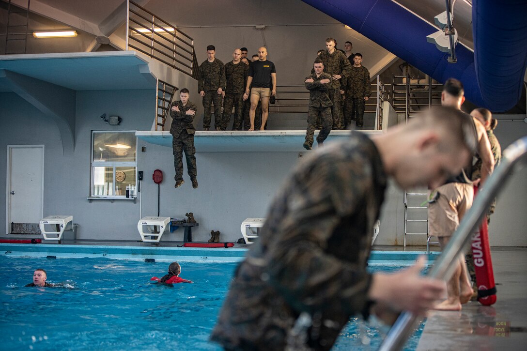 Marines and Sailors with Special Purpose Marine Air-Ground Task Force - Southern Command jump off a tower into a training pool during the basic swim qualification course, a part of the Marine Corps Water Survival Training Program, at Marine Corps Base Camp Lejeune, North Carolina, March 11, 2020. Marines and Sailors with SPMAGTF-SC are conducting a variety of pre-deployment training events and qualifications prior to deploying in order to enhance crisis response readiness in and around Central America, South America and the Caribbean. These events are held at Camp Lejeune and will assist the Marines and Sailors with providing security cooperation training and engineering projects alongside partner nation military forces in the Latin American and Caribbean region, as well as remaining ready to respond to crises in the event of an emergency within the region. (U.S. Marine Corps photo by Sgt. Andy O. Martinez)