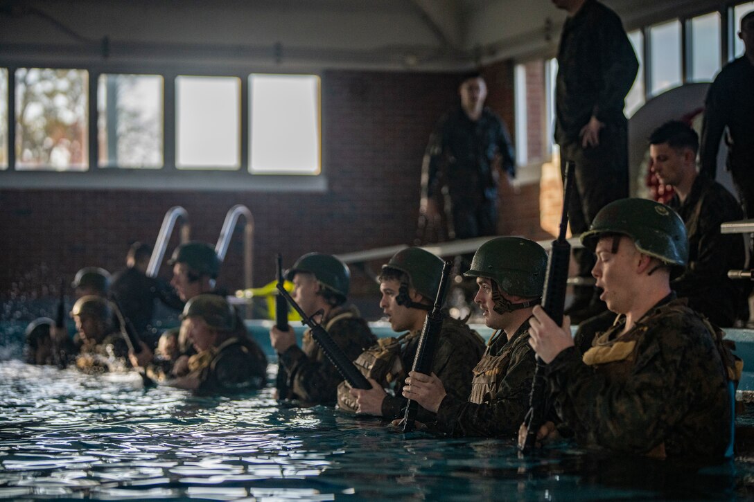 Marines and Sailors with Special Purpose Marine Air-Ground Task Force - Southern Command prepare to shed their personal protective gear underwater during the basic swim qualification course at Marine Corps Base Camp Lejeune, North Carolina, March 11, 2020. SPMAGTF-SC’s Marines and Sailors are conducting a variety of pre-deployment training in order to prepare and be equipped as a naval expeditionary force-in-readiness. These training events assist in maintaining a strong and cohesive Navy and Marine Corps team, allowing the Marines and Sailors of the task force to prepare for accessing key maritime terrain, conduct operations at sea and deploy at a moment’s notice. (U.S. Marine Corps photo by Sgt. Andy O. Martinez)