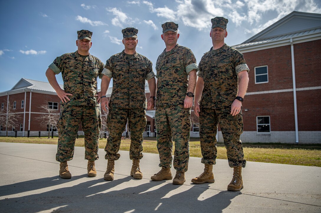 Sgt. Maj. Scott D. Grade, sergeant major of Marine Forces Reserve and Marine Forces North, Lt. Gen. David G. Bellon, commander of Marine Forces Reserve and Marine Forces North, Col. Vincent C. Dawson, commanding officer of Special Purpose Marine Air-Ground Task Force - Southern Command 20, and Sgt. Maj. Mark Murphy, sergeant major of SPMAGTF-SC 20, pose for a photo at Marine Corps Base Camp Lejeune, North Carolina, March 11, 2020. During the visit, Lt. Gen. Bellon stopped at the barracks to review living conditions and presented challenge coins to two Marines for their hard work preparing for the mobilization of the task force. Lt. Gen. Bellon shared his professional guidance and mentorship with the SPMAGTF-SC Marines and Sailors from his experience working in Southern Command’s area of operations. The SPMAGTF are conducting a variety of pre-deployment training events and qualifications in order to enhance crisis response readiness for the Latin American and Caribbean region. (U.S. Marine Corps photo by Sgt. Andy O. Martinez)