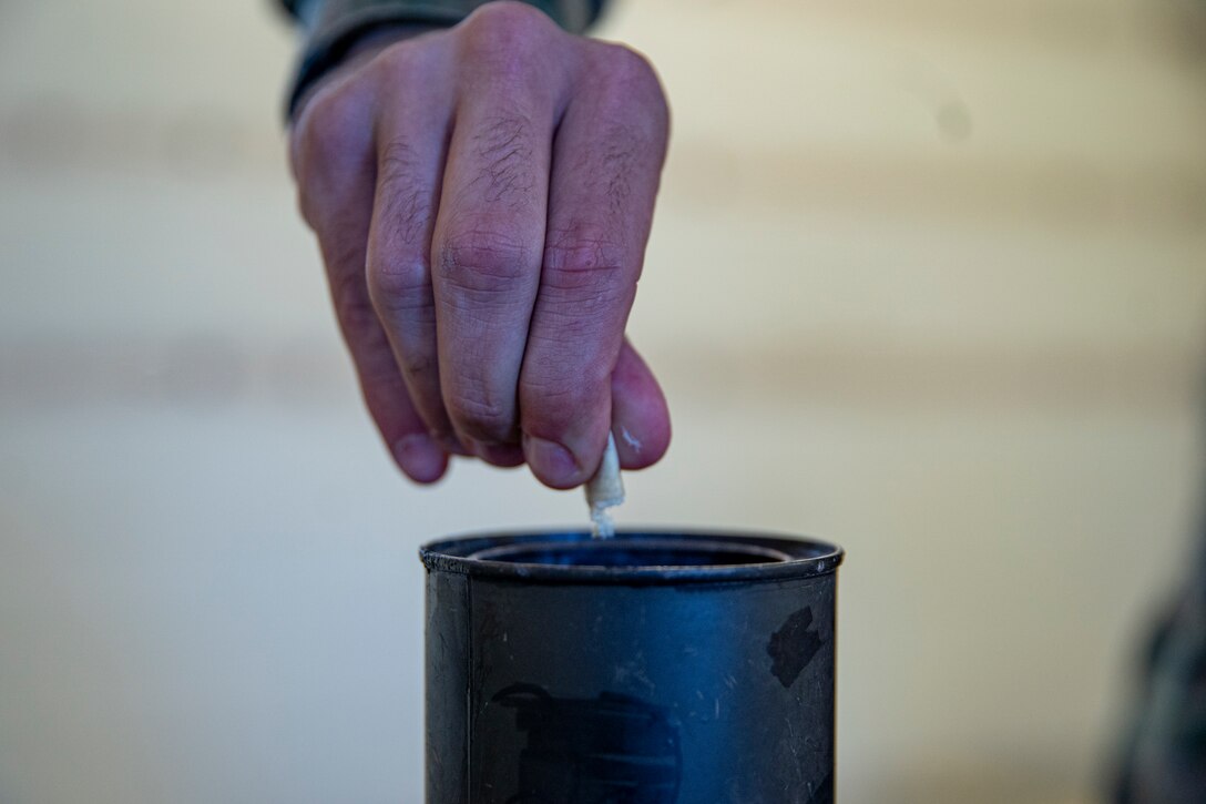 Pfc. Luke Kramer, a chemical, biological, radiological, nuclear defense specialist with 2nd Light Armored Reconnaissance Battalion breaks apart a CS gas capsule during gas chamber training at Marine Corps Base Camp Lejeune, North Carolina, March 16, 2020. This training enhances the task force’s confidence and proficiency with their chemical, biological, radiological, and nuclear equipment. Marines and Sailors with SPMAGTF-SC are conducting a variety of pre-deployment training events and qualifications in order to enhance crisis response preparedness in and around Latin America and the Caribbean. These events assist the Marines and Sailors with providing security cooperation training and engineering projects alongside Partner Nation military forces in Central and South America. Kramer is a native of Manteca, California. (U.S. Marine Corps photo by Sgt. Andy O. Martinez)