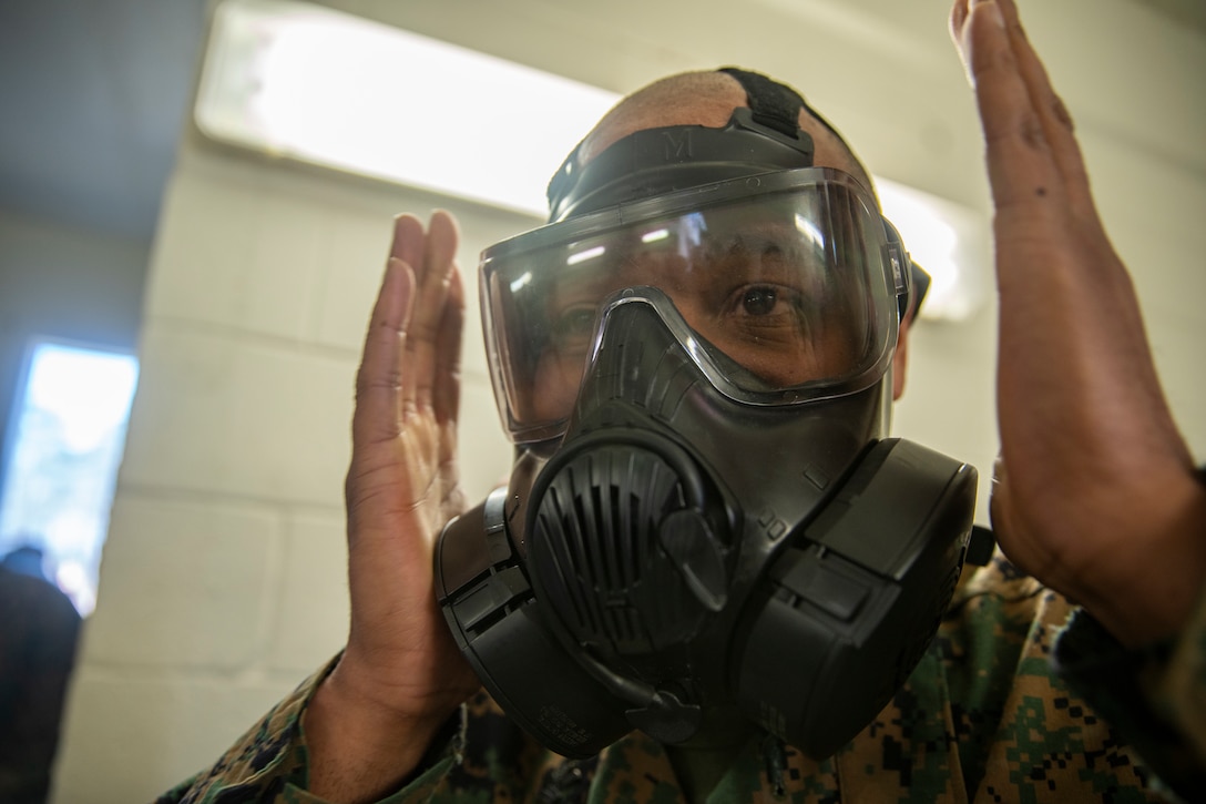 Petty Officer 1st Class Brandon Flake, a hospital corpsman with Special Purpose Marine Air-Ground Task Force - Southern Command clears CS gas out of an M50 gas mask during gas chamber training at Marine Corps Base Camp Lejeune, North Carolina, March 16, 2020. Marines and Sailors with SPMAGTF-SC are conducting a variety of pre-deployment training events and qualifications in order to enhance crisis response preparedness in and around Latin America and the Caribbean. Flake is a native of Romulus, Michigan. (U.S. Marine Corps photo by Sgt. Andy O. Martinez)