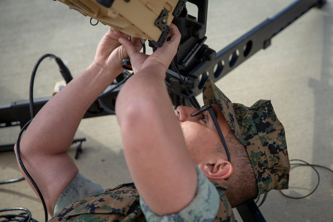 Lance Cpl. Dezmond Gomez, a field radio operator with Special Purpose Marine Air-Ground Task Force - Southern Command, pieces together a rapid response kit for satellite communications at Marine Corps Base Camp Lejeune, North Carolina, March 27, 2020. Marines with SPMAGTF-SC are training with satellite communications equipment to enhance their knowledge and capabilities for upcoming missions. SPMAGTF-SC will be deployed into the Southern Command area of operation to provide crisis response preparedness efforts, security cooperation training and engineering events to help strengthen relations with partner nations throughout Central and South America. Gomez is a native of Kansas City, Missouri. (U.S. Marine Corps photo by Cpl. Benjamin D. Larsen)