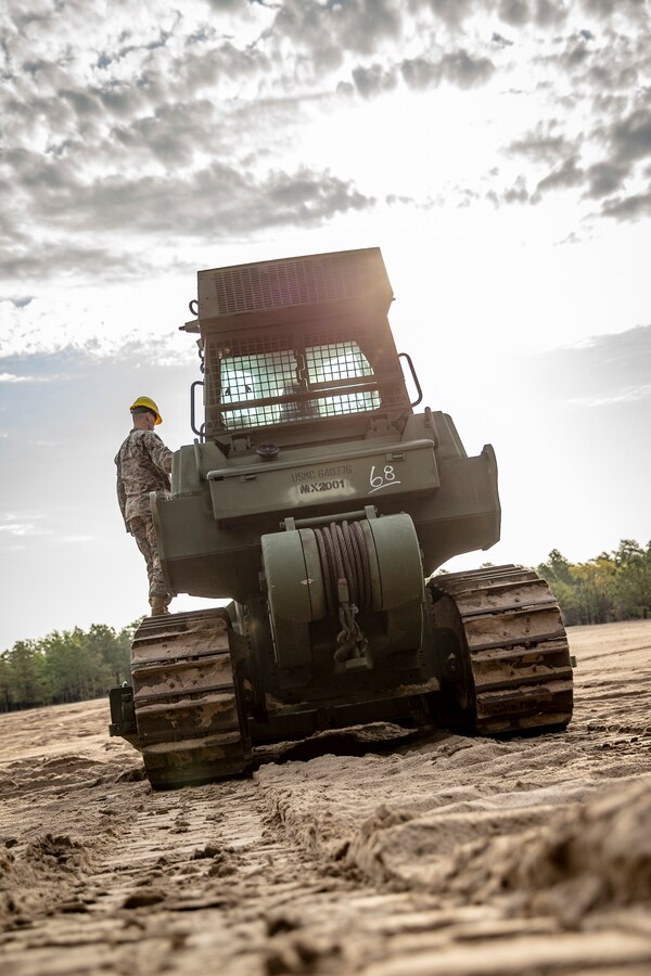 Lance Cpl. Oliver Cravens, a heavy equipment operator with Special Purpose Marine Air-Ground Task Force - Southern Command, conducts a maintenance inspection during a command post exercise at Marine Corps Base Camp Lejeune, North Carolina, April 7, 2020. Daily equipment inspections are essential to the life and dependability of machinery. The Marines and Sailors of SPMAGTF-SC use the training opportunity of the CPX to both show their capabilities in a controlled environment and prepare for the upcoming mission. SPMAGTF-SC is poised to conduct crisis response, theater security cooperation, and general engineering training alongside partner nation militaries in Latin America and the Caribbean. Cravens is a native of Portland, Oregon. (U.S. Marine Corps photo by Cpl. Benjamin D. Larsen)