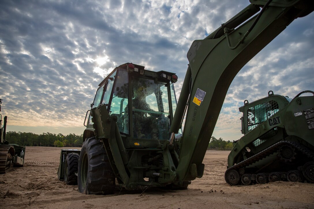 Lance Cpl. Oliver Cravens, a heavy equipment operator with Special Purpose Marine Air-Ground Task Force - Southern Command, conducts a maintenance inspection during a command post exercise at Marine Corps Base Camp Lejeune, North Carolina, April 7, 2020. Daily equipment inspections are essential to the life and dependability of machinery. The Marines and Sailors of SPMAGTF-SC use the training opportunity of the CPX to both show their capabilities in a controlled environment and prepare for the upcoming mission. SPMAGTF-SC is poised to conduct crisis response, theater security cooperation, and general engineering training alongside partner nation militaries in Latin America and the Caribbean. Cravens is a native of Portland, Oregon. (U.S. Marine Corps photo by Cpl. Benjamin D. Larsen)