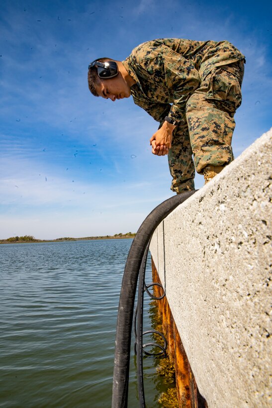 Lance Cpl. Brandon Drapela, a water support technician with Special Purpose Marine Air-Ground Task Force - Southern Command, reviews water hoses pumping water into a lightweight water purification system during a command post exercise at Camp Lejeune, North Carolina, April 7, 2020. The CPX improves war-fighting capabilities while conducting realistic training to exercise command and control. SPMAGTF-SC will be deployed into the Southern Command area of operation to provide crisis response preparedness efforts, security cooperation training and engineering events to help strengthen relations with partner nations throughout Central and South America. Drapela is a native of Corvallis, Oregon. (U.S. Marine Corps photo by Sgt. Andy O. Martinez)