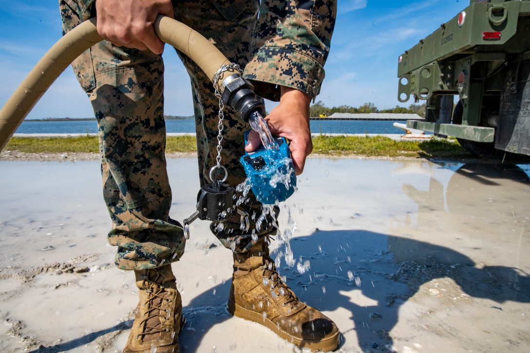 Lance Cpl. Joseph Sacco, a water support technician with Special Purpose Marine Air-Ground Task Force - Southern Command, checks recently purified water’s chlorine level using an ultrameter device during a command post exercise at Camp Lejeune, North Carolina, April 7, 2020. The CPX increases readiness and challenges SPMAGTF-SC command and control, communications and timely decision-making capabilities through simulated real-world scenarios. SPMAGTF-SC will be deployed into the Southern Command area of operation to provide crisis response preparedness efforts, security cooperation training and engineering events to help strengthen relations with partner nations throughout Central and South America. Sacco is a native of Beaverton, Oregon. (U.S. Marine Corps photo by Sgt. Andy O. Martinez)