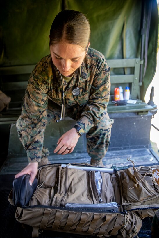 Navy Petty Officer 2nd Class Jenna Bentle, a hospital corpsman with Special Purpose Marine Air-Ground Task Force - Southern Command, reviews her medical bag during a command post exercise at Camp Lejeune, North Carolina, April 7, 2020. The CPX increases readiness and challenges SPMAGTF-SC command and control, communications and timely decision-making capabilities through simulated real-world scenarios. SPMAGTF-SC will be deployed into the Southern Command area of operation to provide crisis response preparedness efforts, security cooperation training and engineering events to help strengthen relations with partner nations throughout Central and South America. Bentle is a native of Green Bay, Wisconsin. (U.S. Marine Corps photo by Sgt. Andy O. Martinez)