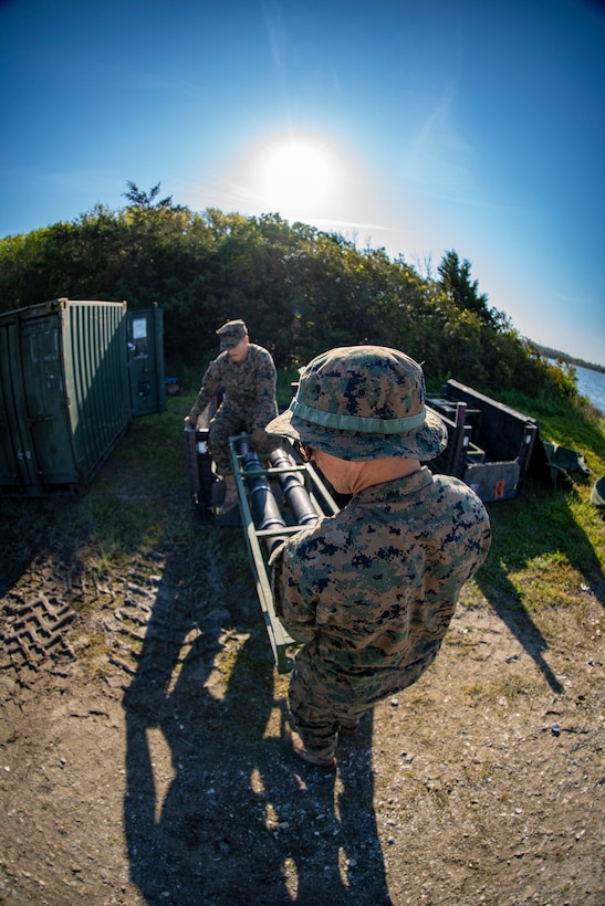 Lance Cpl. Brandon Drapela, back, and Lance Cpl. Daniel Bordenave, front, both water support technicians with Special Purpose Marine Air-Ground Task Force - Southern Command, move equipment for the lightweight water purification system during the command post exercise at Camp Lejeune, North Carolina, April 8, 2020. Water support technician Marines used lightweight water purification systems to purify water before providing it to the combat engineer Marines working at another site. The CPX increases readiness and challenges SPMAGTF-SC command and control, communications and timely decision-making capabilities through simulated real-world scenarios. SPMAGTF-SC will be deployed into the Southern Command area of operation to provide crisis response preparedness efforts, security cooperation training and engineering events to help strengthen relations with partner nations throughout Central and South America. Drapela is a native of Corvallis, Oregon. Bordenave is from Pleasanton, California. (U.S. Marine Corps photo by Sgt. Andy O. Martinez)