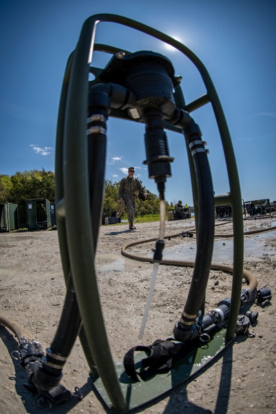 Lance Cpl. Joseph Sacco, a water support technician with Special Purpose Marine Air-Ground Task Force - Southern Command, unloads water hoses to set up a lightweight water purification system during a command post exercise at Camp Lejeune, North Carolina, April 8, 2020. Water support technician Marines used lightweight water purification systems to purify water before providing it to the combat engineer Marines working at another site. The CPX increases readiness and challenges SPMAGTF-SC command and control, communications and timely decision-making capabilities through simulated real-world scenarios. SPMAGTF-SC will be deployed into the Southern Command area of operation to provide crisis response preparedness efforts, security cooperation training and engineering events to help strengthen relations with partner nations throughout Central and South America. Sacco is a native of Beaverton, Oregon. (U.S. Marine Corps photo by Sgt. Andy O. Martinez)