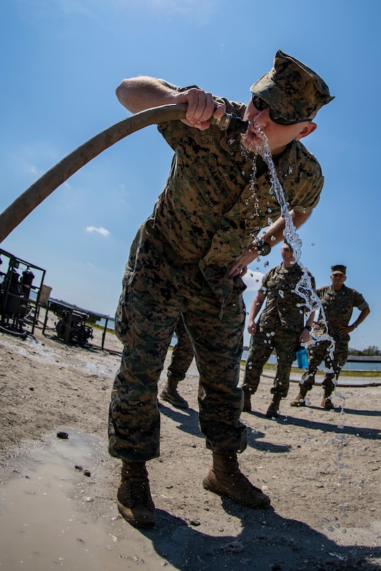 Col. Vincent Dawson, the commanding officer of Special Purpose Marine Air-Ground Task Force - Southern Command, taste-tests purified water during a command post exercise at Camp Lejeune, North Carolina, April 8, 2020. The CPX increases readiness and challenges SPMAGTF-SC command and control, communications and timely decision-making capabilities through simulated real-world scenarios. SPMAGTF-SC will be deployed into the Southern Command area of operation to provide crisis response preparedness efforts, security cooperation training and engineering events to help strengthen relations with partner nations throughout Central and South America. Dawson is a native of Portland, Oregon. (U.S. Marine Corps photo by Sgt. Andy O. Martinez)